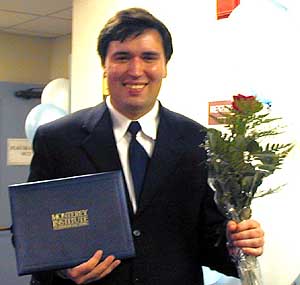 Daniil with flowers and his diploma