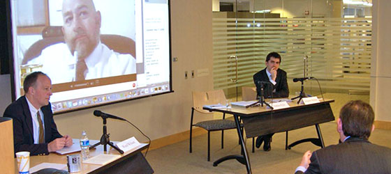 Sandy Spector (right) asks a question as Ward Wilson (left), Russell Leslie (on screen) and Grégoire Mallard (center) look on.