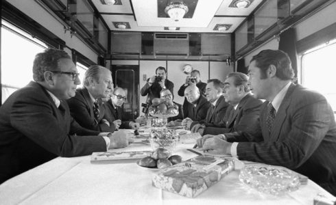 President Gerald Ford, Secretary of State Henry Kissinger, and other US representatives meeting with General Secretary Leonid Brezhnev, Foreign Secretary Andrei Gromyko, Ambassador Anatoly Dobrynin, and others aboard a Russian train headed for Vladivostok, November 23, 1974. Image courtesy of the Gerald R. Ford Presidential Library. (Src: Wikimedia Commons)