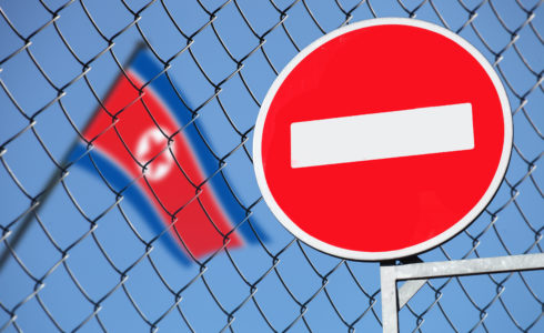 North Korea flag and stop sign (Src: Shutterstock)