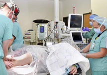 Doctors with a patient lying on a table with medical equipment