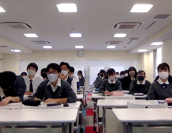 Japanese students at desks wearing dust masks