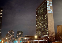 UN Building in New York at night with words projected Nuclear Weapons Now Illegal