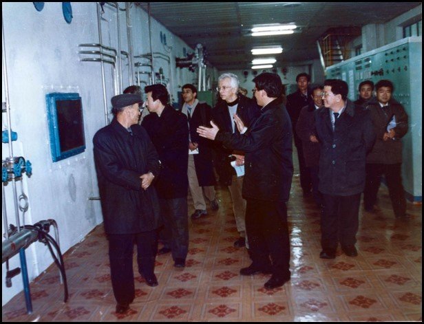 Group of men walking in the hallway of a science facility in Yongbyon, North Korea