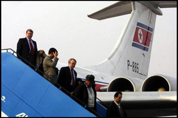 People exiting the plane. Air Koryo logo shows large on the tail.