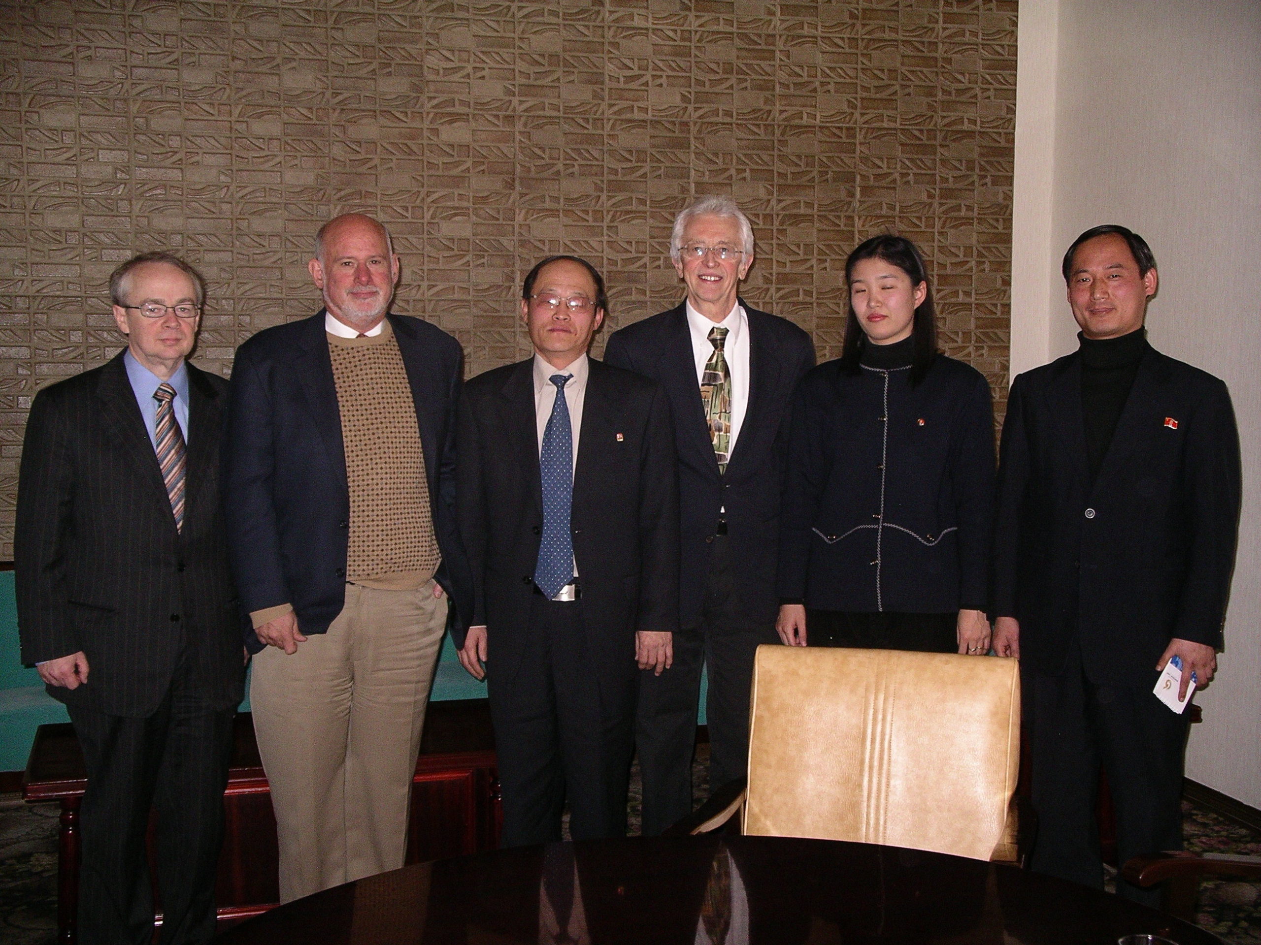Three Americans and three Korean officials posing for a friendly photo