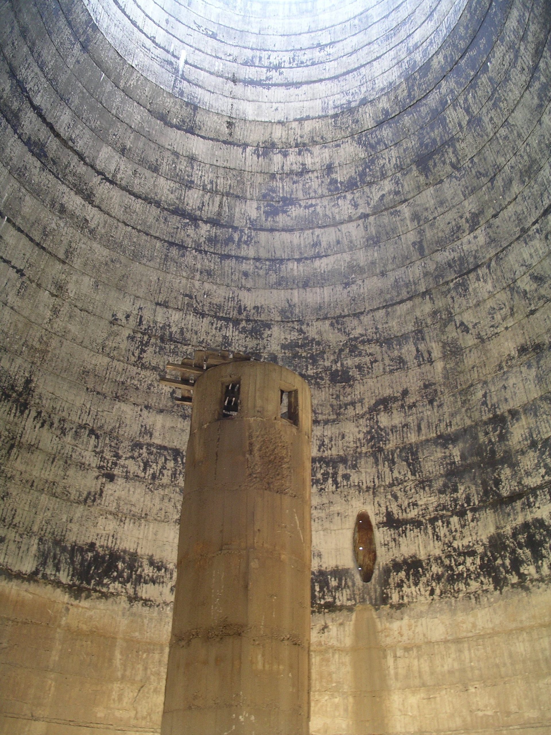 Inside view of the cooling tower with bare walls stripped of former equipment