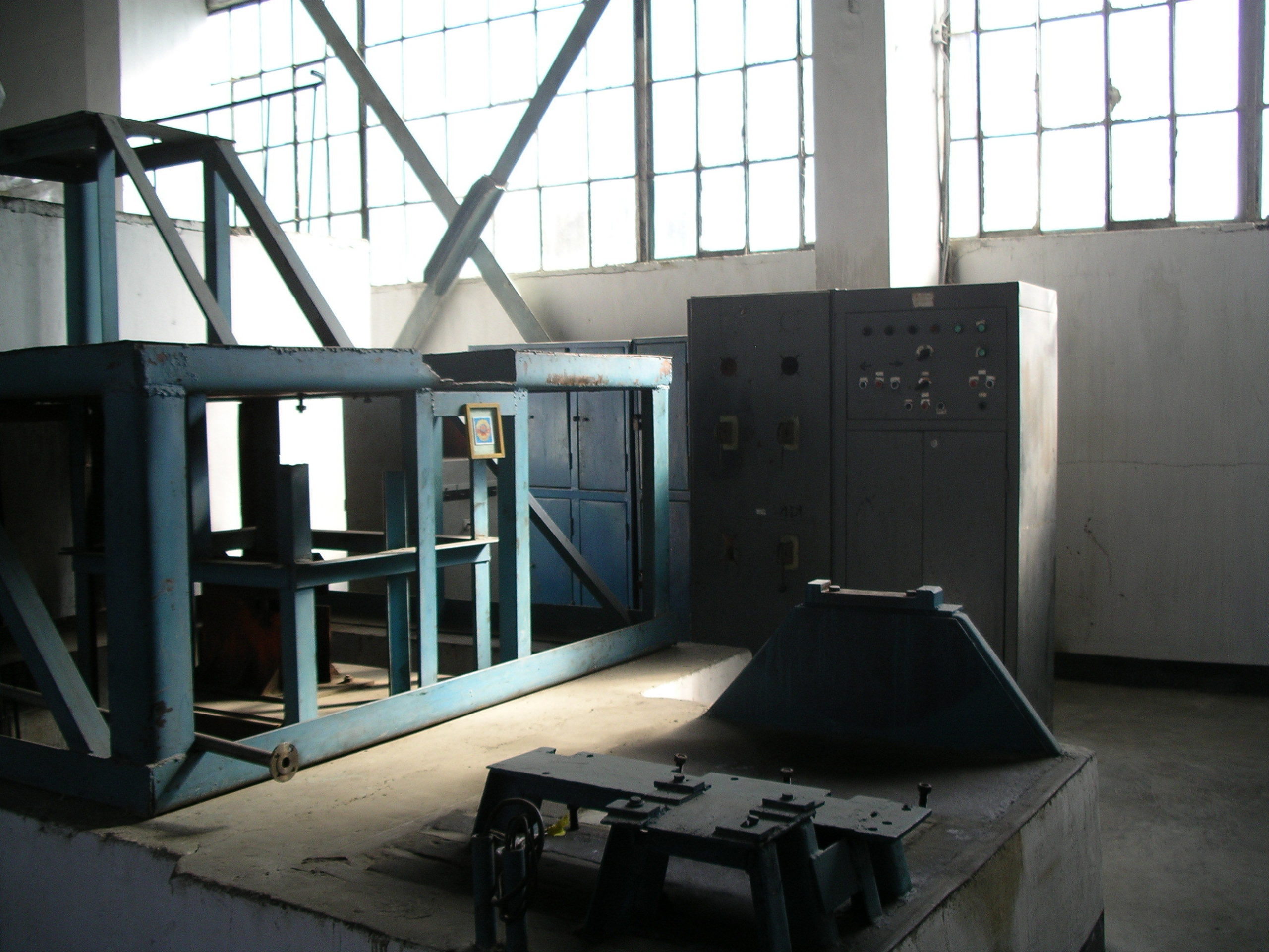 Industrial space with large window running the length of the wall and some steel structures and beams