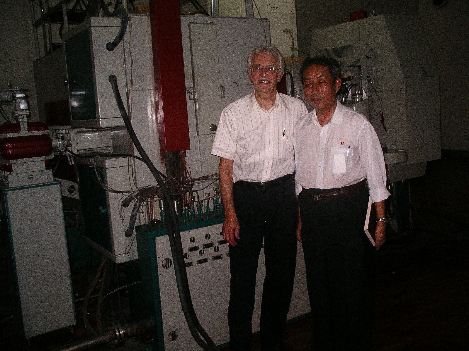Two men posing for a photo in a scientific lab setting