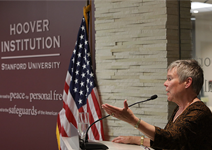 Rose Gottemoeller at a podium with US flag behind