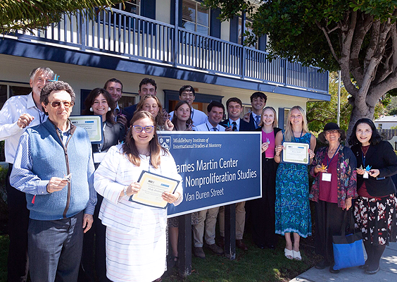 Students, experts, and donors standing around the CNS sign