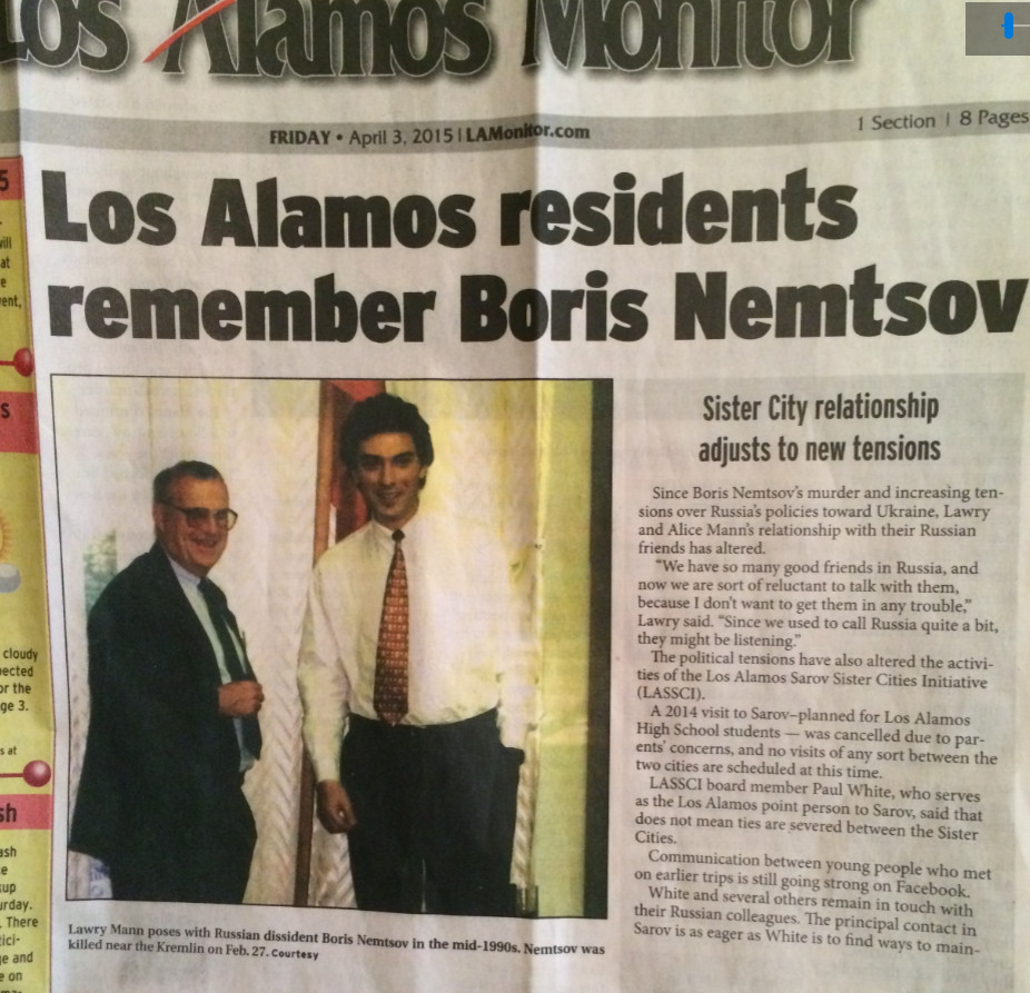 Photograph of a newspaper with an image of a photograph with two men.