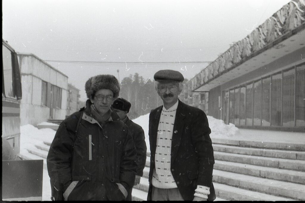 Two men in coats and hats standing for the camera