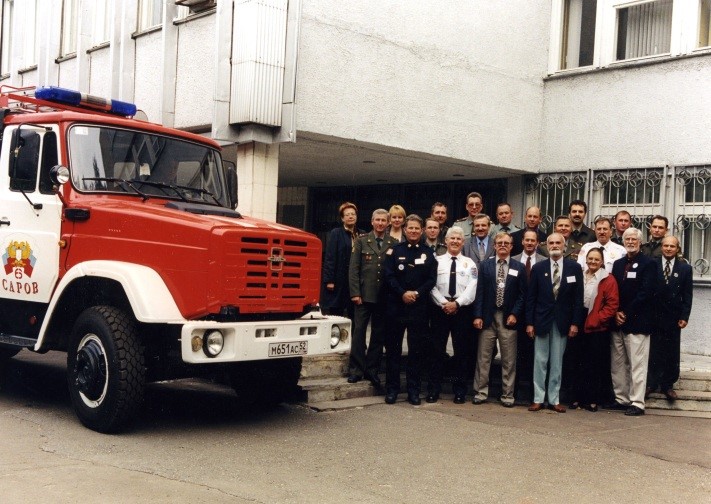 Group standing outside beside a fire truck