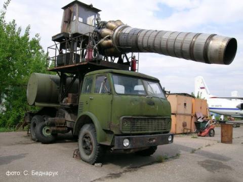Large green truck with tall large equipment