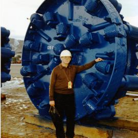 V. Dorodnov of the Soviet delegation in front of a 120-inch drill bit at the Nevada Test Site. January 29, 1988