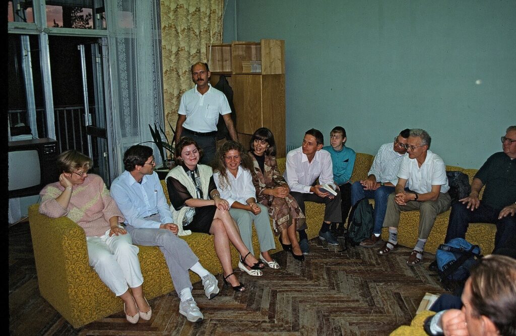 Group of people talking indoors in a living room atmosphere