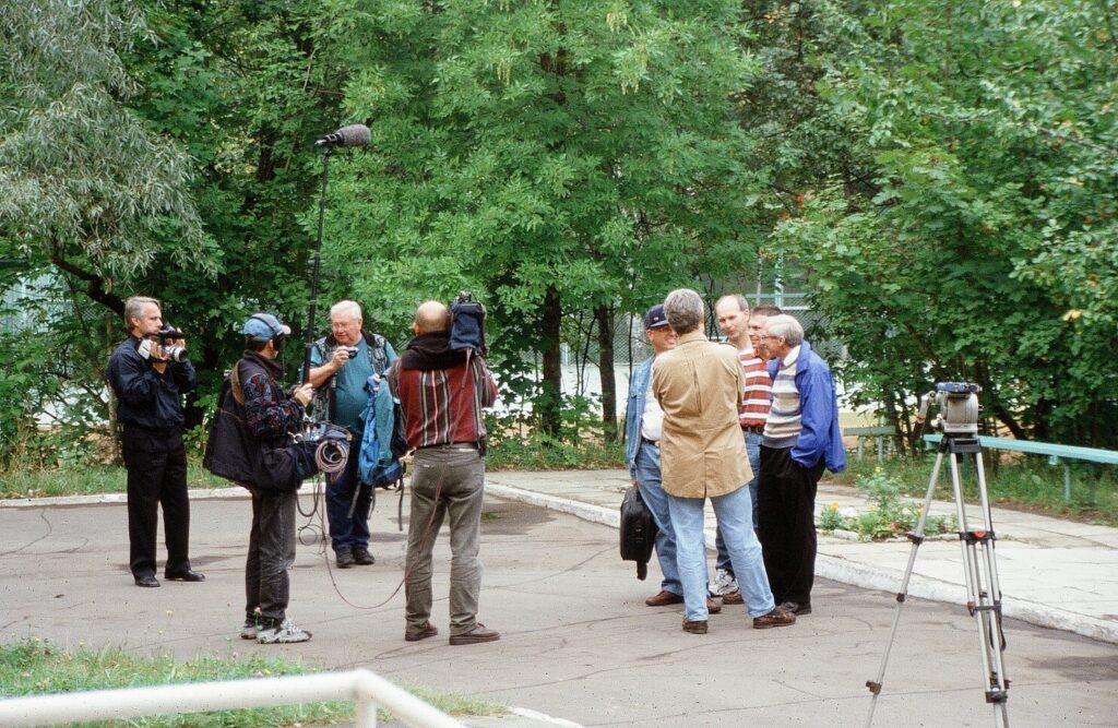 Group with cameras standing outside