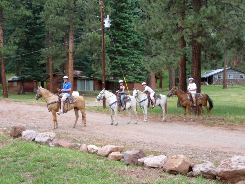 Four people on horseback.